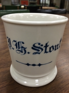 Ceramic mug with J.H. Stout painted on its side.